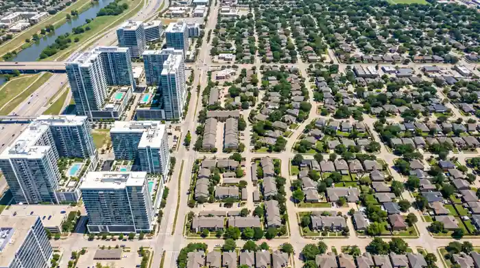 Aerial view of Dallas neighborhoods showing mix of urban high-rises and suburban residential areas