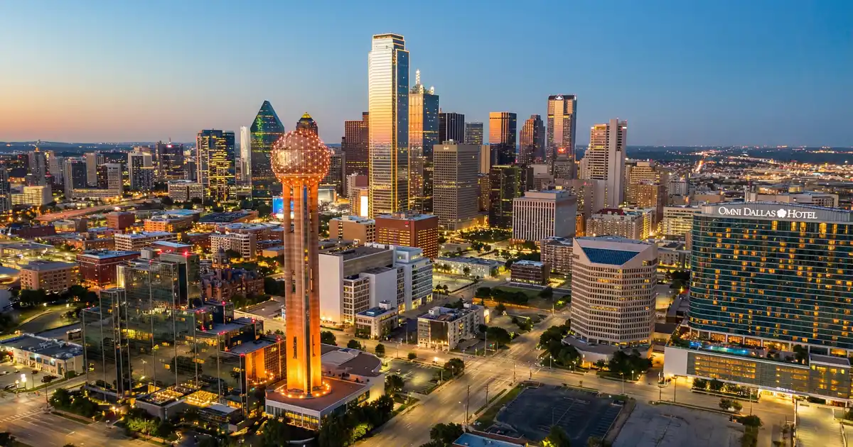 Downtown Dallas skyline with Reunion Tower at dusk — the view that draws thousands of newcomers every month