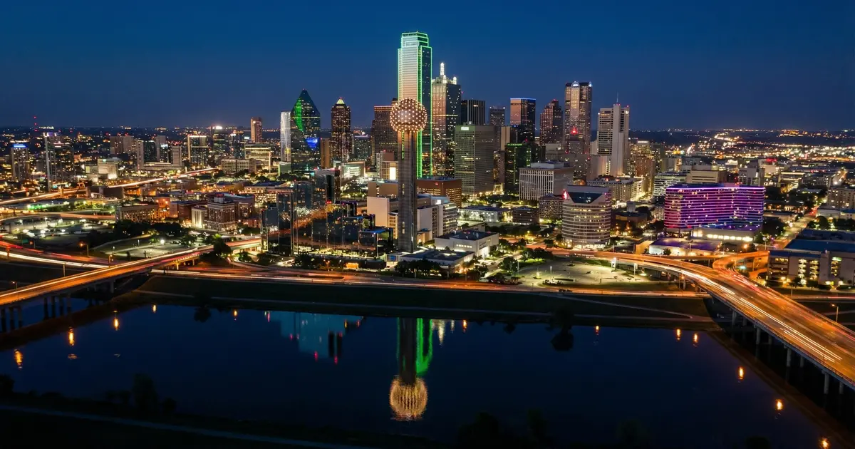 Dallas skyline with Reunion Tower at night reflecting city lights — the salary question every newcomer asks before moving