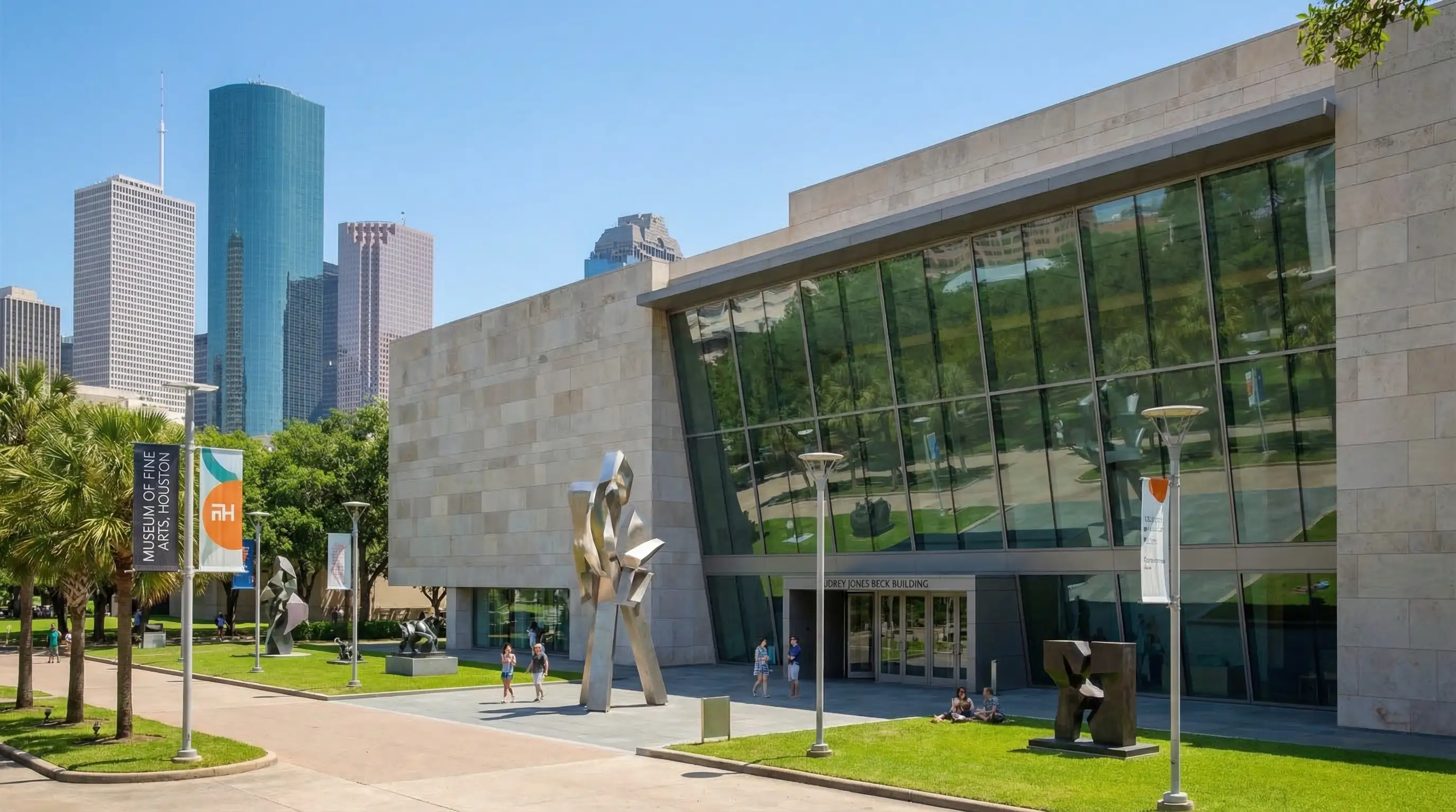 Museum of Fine Arts Houston — Audrey Jones Beck Building exterior with sculpture garden, Houston skyline in background, and palm trees lining the Museum District