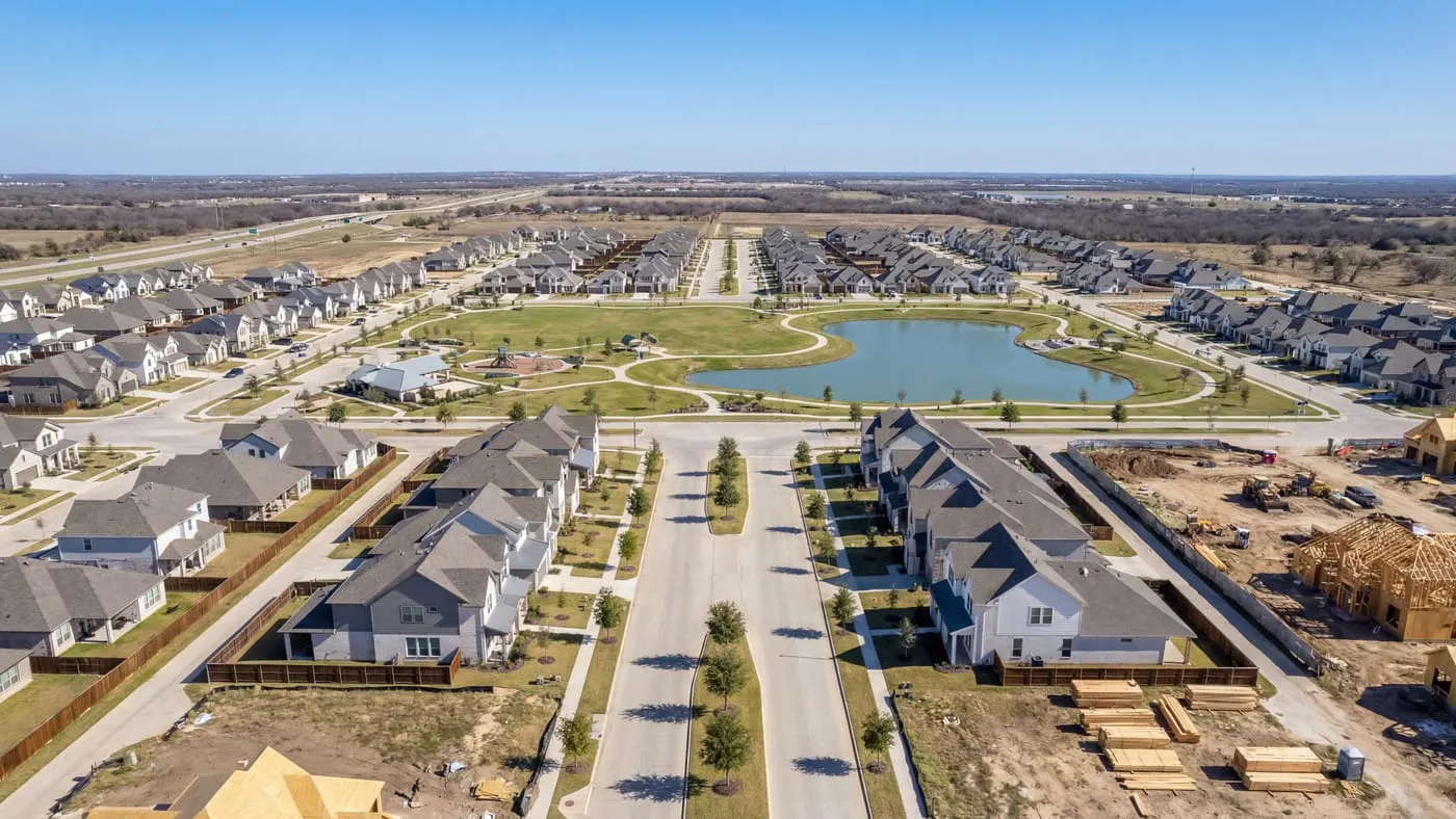 Aerial view of fast growing Texas master planned suburb with new construction parks and trails