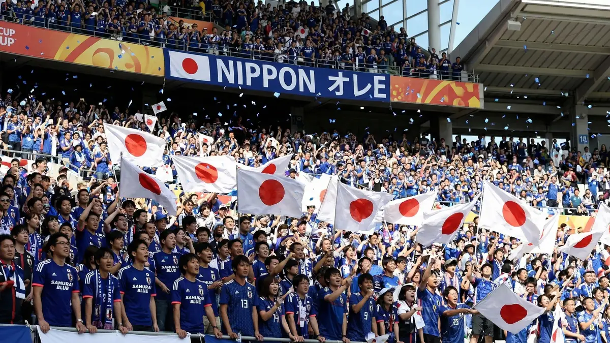 Japan Samurai Blue supporters at AT&T Stadium Dallas waving flags and scarves for World Cup 2026